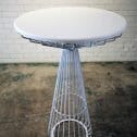 Stylish white table with a metal frame and a pristine white surface, great for your next event.