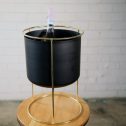 A bottle of champagne sits in a modern black and gold bucket, embodying the elegance and joy of your next party event.