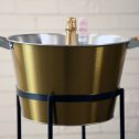 A chic golden champagne bucket, elegantly set on a stand, ideal for enhancing your celebratory events.