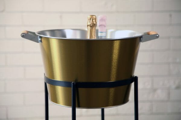 GOLD ICE BUCKETS - BLACK STAND 04_resized A chic golden champagne bucket, elegantly set on a stand, ideal for enhancing your celebratory events.
