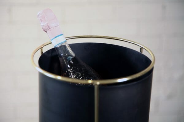 BLACK AND GOLD WINE BUCKET A bottle of champagne rests elegantly in a sleek black and gold bucket, showcasing a moment of celebration and luxury, perfect for your party or event.