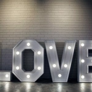 A large, illuminated sign reading "LOVE" - the Light Up LOVE Letters are perfect for all types of events, available for hire from RSVP Event Hire in Perth.