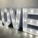 A glowing sign that says "LOVE" a charming addition for events, available for rental from RSVP Event Hire in Perth.