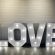 A bright white sign displaying the word "LOVE" ideal for events, offered for hire by RSVP Event Hire in Perth.