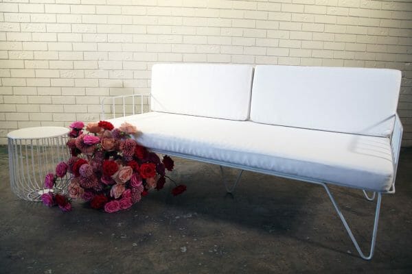 WHITE WIRE COUCH 03_resized Elegant white couch featuring metal legs and a white cushion, ideal for any event, offered for hire by RSVP Event Hire in Perth.
