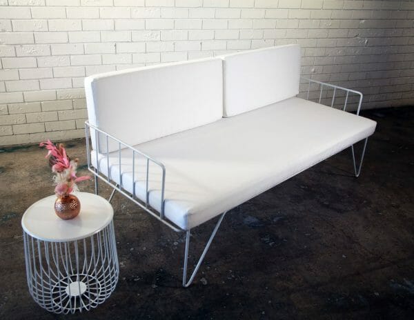 WHITE WIRE COUCH 04_resized Modern white couch with sleek metal legs and a white cushion, great for events, available for hire from RSVP Event Hire in Perth.