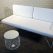 Modern white couch with sleek metal legs and a white cushion, great for events, available for hire from RSVP Event Hire in Perth.