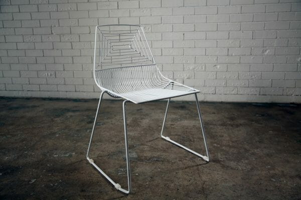 WHITE WIRE DINING CHAIR 01_resize A stylish white wire dining chair with a metal frame and soft white cushion, perfect for any modern setting available from RSVP Event Hire in Perth.