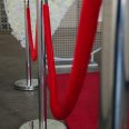 A vibrant red carpet laid out, surrounded by six stylish bollards for your next event, from RSVP Event Hire in Perth, creating an elegant entrance.