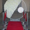 A striking red carpet and white flower backdrop, complemented by RSVP Event Hire's set of 6 Stylish Bollards, perfect for your next event in Perth.