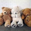 Three giant teddy bears sitting on the floor, ready to bring joy to your event from RSVP Event Hire.