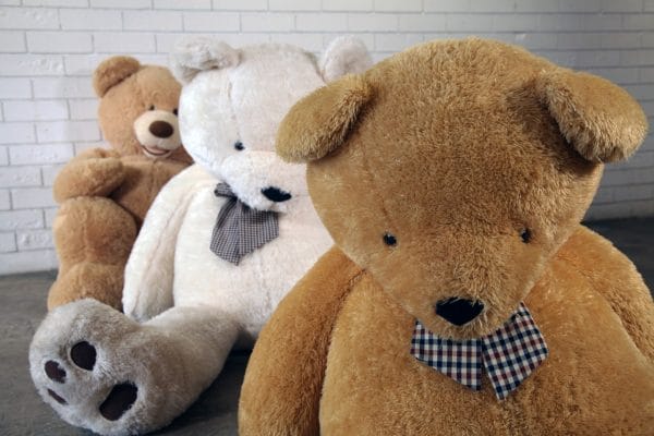 GIANT TEDDY BEARS A charming scene of three giant teddy bears on the floor, perfect for events, available for hire from RSVP Event Hire.