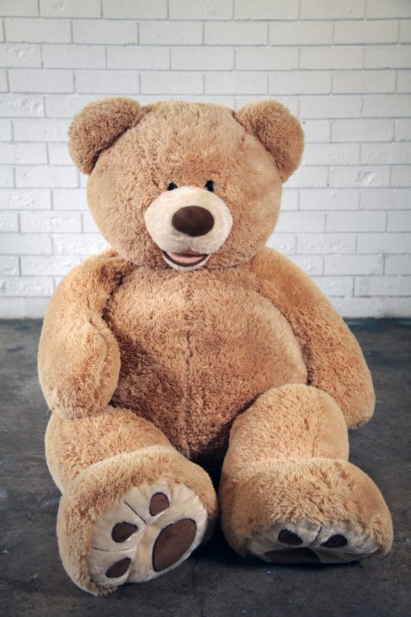 GIANT TEDDY A giant teddy bear sitting on the floor, ready to bring joy to your event from RSVP Event Hire.
