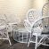 2. Elegant white wicker table and chairs, ideal for gatherings, offered by RSVP Event Hire in Perth.
